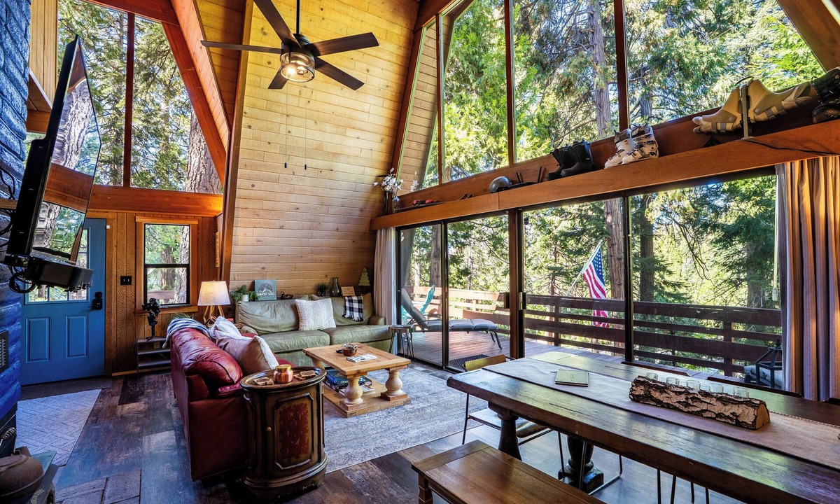 Sierra Cedars Cabin | Tucked in the trees, Cedar Hill is a cozy A-frame cabin with modern updates, a spacious kitchen, wraparound deck, and stunning views. The perfect mountain escape for families, couples, and friends—plus, it's pet-friendly!