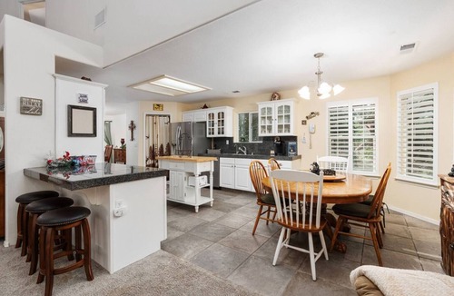 Shaver Lake House | Family-friendly mountain retreat with two game rooms, a screened-in patio with firepit, garage game zone, hot tub, sauna, yoga mats, and beautiful Sierra views.