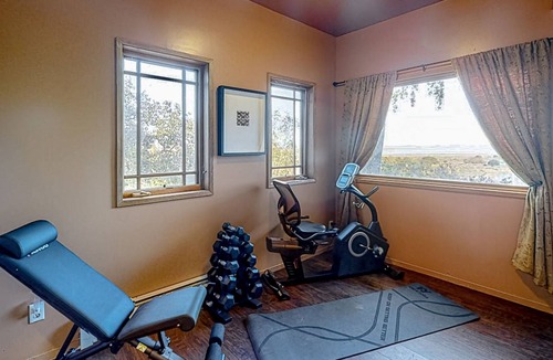 Black Point-Green Point House | Gorgeous river view home with wood stove, sauna, patio, fitness room, & kitchen