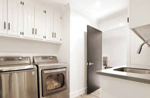 Modesto House | Lux Home wall-to-wall shower with nine heads ensuring a luxurious experience.