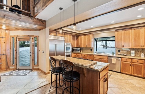 Shaver Lake House | Luxury Shaver Lake retreat with pond views, soaring wood ceilings, a stone fireplace, gourmet kitchen, four bedrooms, a loft, spacious backyard, and a brand-new spa. Perfect for families and groups seeking a mountain getaway.