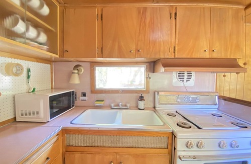 Kernville House | Vintage wood paneled travel trailer on Kernville Ranch: horses, river, hot tub