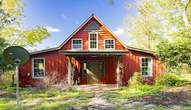 Private cabin built over a lake with a large breezy screened-in porch. in Silverhill