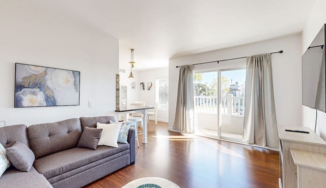 Sunny condo by the beach with a full kitchen, balcony, & water view